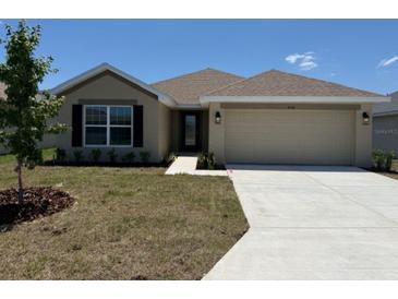Charming one-story home with a two-car garage, manicured lawn, and a traditional architectural style at 2158 Nw 23Rd Loop, Ocala, FL 34475
