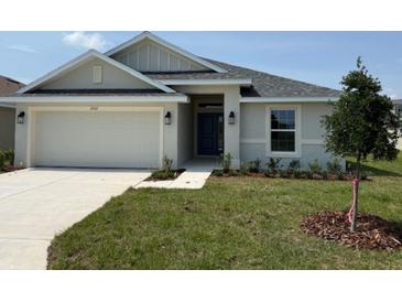 Charming single-Gathering home featuring a two-car garage, a well-maintained lawn, and a covered front entryway at 2162 Nw 23Rd Loop, Ocala, FL 34475