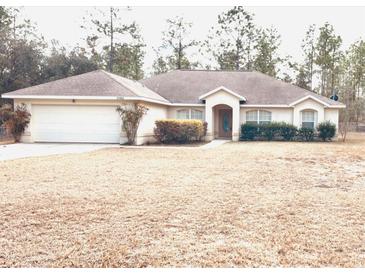 One-story house with attached garage and manicured lawn at 21962 Sw Nautilus Blvd, Dunnellon, FL 34431