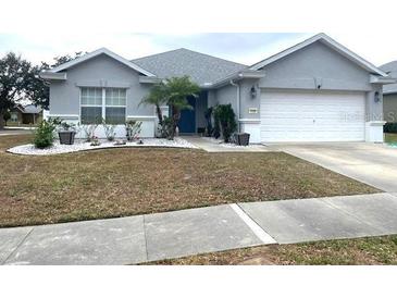 Well-maintained single-story home with a two-car garage and landscaping at 4036 Sw 57Th Ct, Ocala, FL 34474