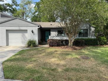 Charming single-story home featuring a well-maintained lawn and inviting front entrance at 1936 Se 37Th Court Cir, Ocala, FL 34471