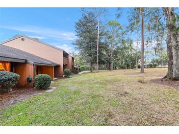 Spacious backyard with grassy area and mature trees at 19660 Sw 83Rd Place Rd # C18, Dunnellon, FL 34432