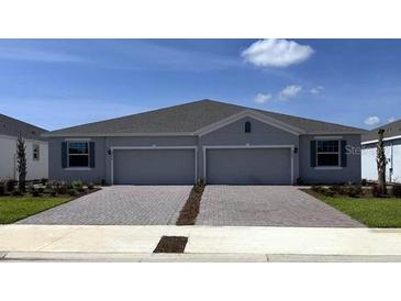 Charming home featuring a paved driveway and a well-maintained lawn and an attached two car garage at 4736 Nw 39Th Street Rd, Ocala, FL 34482