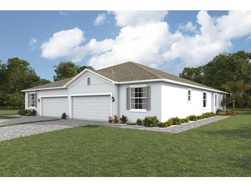 Two-car garage home with light gray exterior, landscaping and a paved driveway at 4742 Nw 39Th Street Rd, Ocala, FL 34482