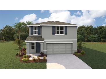 Two-story house with gray siding, two-car garage, and landscaping at 8699 Sw 44Th Ter, Ocala, FL 34476