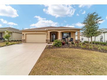 One-story home with attached garage and landscaped front yard at 9958 Sw 97Th Ln, Ocala, FL 34481