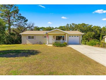 Ranch-style home with attached garage, front porch, and spacious yard at 11250 Sw 79Th Ter, Ocala, FL 34476