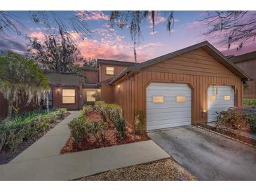 Two-story townhome with double garage and landscaped walkway at 2701 Ne 10Th St # 707, Ocala, FL 34470