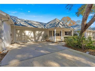 Front view of a single-story home with a carport and landscaped yard at 8681 Sw 93Rd Pl # B, Ocala, FL 34481