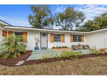 Renovated home featuring a gray front door and updated landscaping at 900 Mulberry St, Fruitland Park, FL 34731