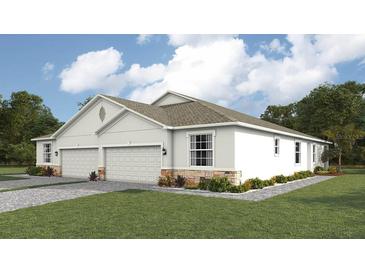 Two-car garage, light colored exterior, landscaping at 4748 Nw 39Th Street Rd, Ocala, FL 34482