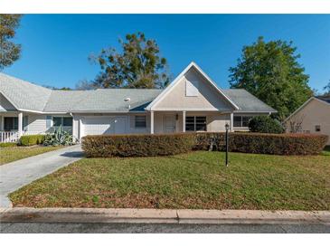 Charming single-story home featuring a well-manicured front yard, attached garage, and inviting entrance at 8569 Sw 92Nd Ln # F, Ocala, FL 34481