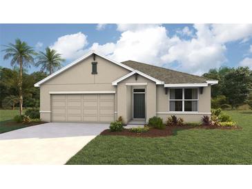 Single-story home with a two-car garage and landscaped front yard at 354 Hickory Course Trl, Ocala, FL 34472