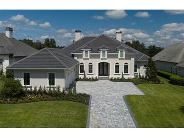 Two-story home with gray stone driveway and landscaped lawn at 7647 Nw 33Rd Pl, Ocala, FL 34482