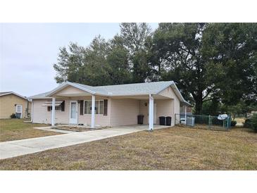 Tan single story house with carport and fenced backyard at 8511 Sw 107Th Pl, Ocala, FL 34481