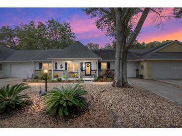 Inviting house exterior featuring a charming front porch and well-manicured landscaping at 8723 Sw 93Rd Ln # C, Ocala, FL 34481