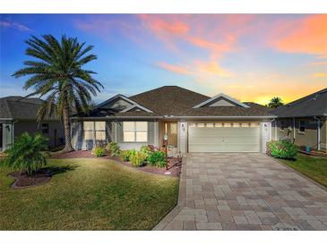 Attractive single-story home with landscaped yard and paver driveway at 2304 Grenadier Way, The Villages, FL 32162