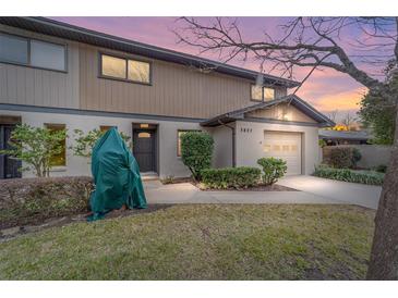 Two-story condo with attached garage, landscaping, and walkway at 3827 Ne 17Th Street Cir, Ocala, FL 34470