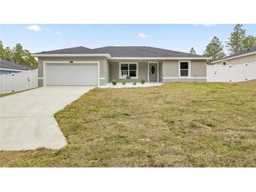 Newly constructed home with attached garage and neat landscaping at 4335 Sw 159Th Ave, Ocala, FL 34481