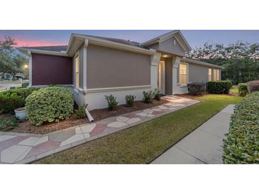 Two-toned house with a stone walkway and landscaping at 6751 Sw 91St Cir, Ocala, FL 34481