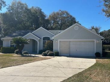 Single-story house with attached garage and manicured lawn at 8027 Sw 116Th Loop, Ocala, FL 34481