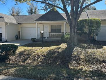 Exterior view of a single story home with attached garage and manicured lawn at 9394 Sw 97Th Ln # B, Ocala, FL 34481