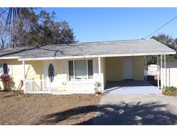 Cute yellow house with carport and white trim at 21465 Sw Honeysuckle St, Dunnellon, FL 34431