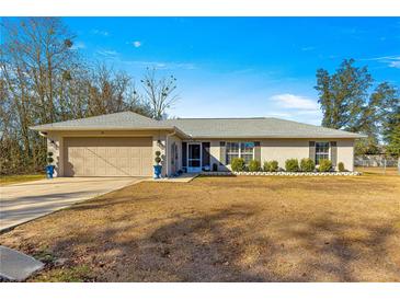 Single-story home with attached garage and yard at 24 Pine Course Pl, Ocala, FL 34472
