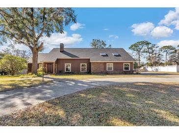 Brick ranch home with a large yard and driveway at 700 Se 49Th Ave, Ocala, FL 34471