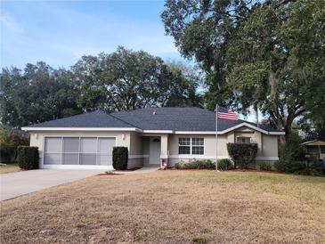 Single-story home with a grey roof and American flag at 7375 Sw 106Th St, Ocala, FL 34476