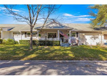 Inviting home exterior with a charming porch and well-manicured lawn at 8677 Sw 95Th Ln # F, Ocala, FL 34481