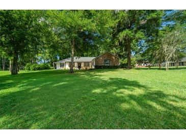 Charming one-story home nestled on a spacious lot with lush lawn at 8930 Sw 8Th St, Ocala, FL 34481