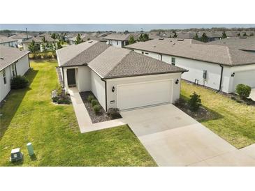 One-story house with a two-car garage and a nicely landscaped yard, in a residential area at 9326 Sw 52Nd Loop, Ocala, FL 34481