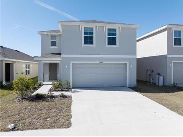 Two-story house with gray siding, two-car garage, and landscaping at 8642 Sw 46Th Ave, Ocala, FL 34476