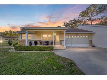 Charming single-story home with well-manicured lawn, cozy front porch, and attached two-car garage at 8648 Sw 95Th Ln # A, Ocala, FL 34481