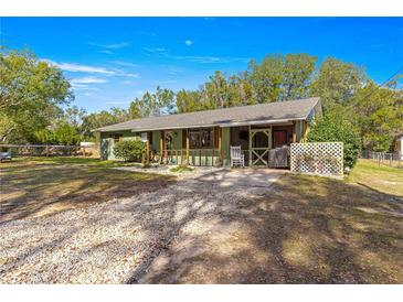 Ranch style home with covered porch and spacious yard at 10425 Se 159Th Lane, Summerfield, FL 34491