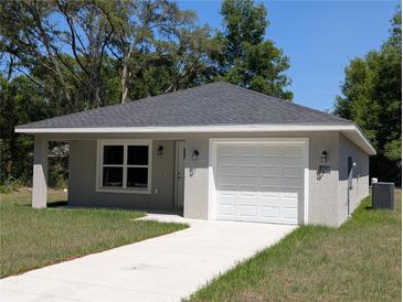 Charming single-story home with well-maintained lawn and attached one car garage at 14259 Se 33Rd Ter, Summerfield, FL 34491