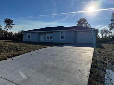 Newly constructed home with driveway and landscaping at 15801 Sw 37Th Cir, Ocala, FL 34473