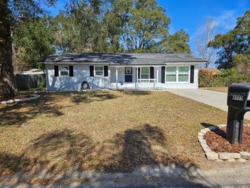 Newly painted house with a well-maintained lawn and landscaping at 3333 Se 12Th St, Ocala, FL 34471