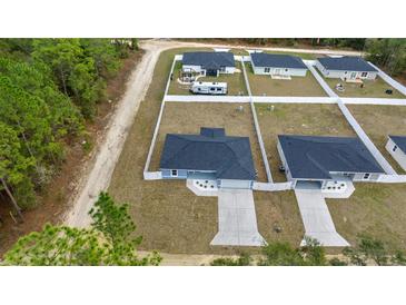 Aerial view of new construction homes with private driveways and fenced yards at 4317 Sw 159Th Ave, Ocala, FL 34481