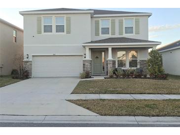 Two-story house with a two-car garage and a well-manicured lawn at 4321 Sw 52Nd Lane Rd, Ocala, FL 34474