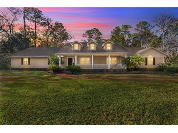 Beautiful house with a large front porch and well-manicured lawn at 5000 Se 11Th Ave, Ocala, FL 34480