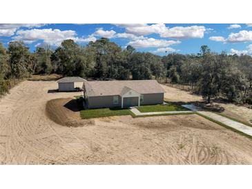 New construction home featuring concrete driveway, front yard grass and side yard shed at 5885 Sw 169Th Ct, Ocala, FL 34481