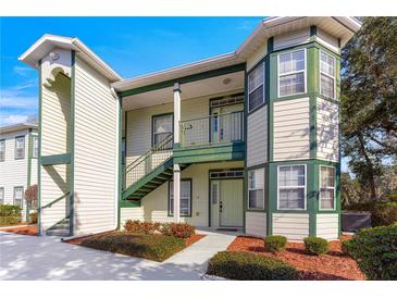 Two-story townhome with green accents and landscaping at 231 Ne 28Th Ave # 301, Ocala, FL 34470