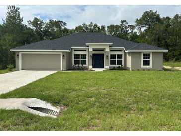 Charming single-story home featuring a well-manicured lawn and inviting curb appeal at 35 Locust Radial Cir, Ocala, FL 34472
