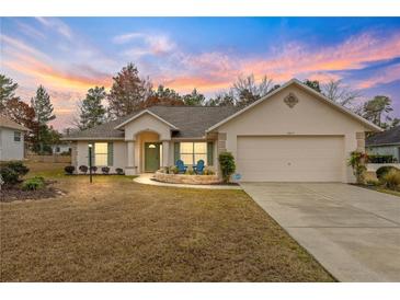 Charming one-story home with a two-car garage and well-manicured lawn at 5077 Sw 107Th Loop, Ocala, FL 34476