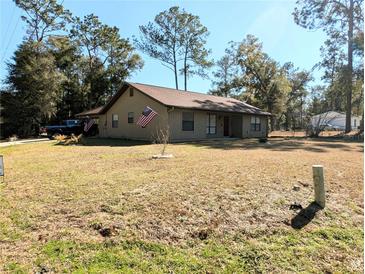 Ranch-style home with carport and spacious yard at 5991 Nw 61St Ct, Ocala, FL 34482