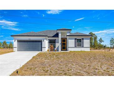 White house with gray garage door and yellow front door at 15413 Sw 65Th Terrace Rd, Ocala, FL 34473