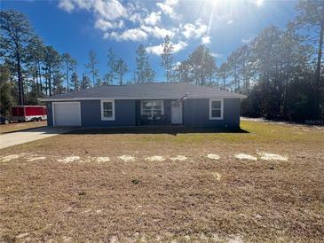 Newly constructed home with gray exterior and a spacious yard at 23092 Sw Nautilus Blvd, Dunnellon, FL 34431