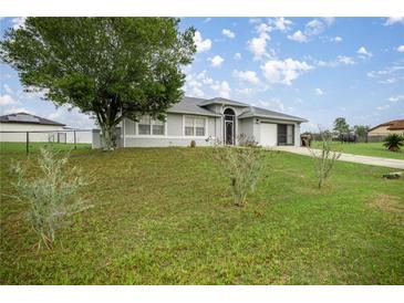 Charming single-story home featuring a well-maintained lawn and attached two car garage at 331 Oak Lane Dr, Ocala, FL 34472